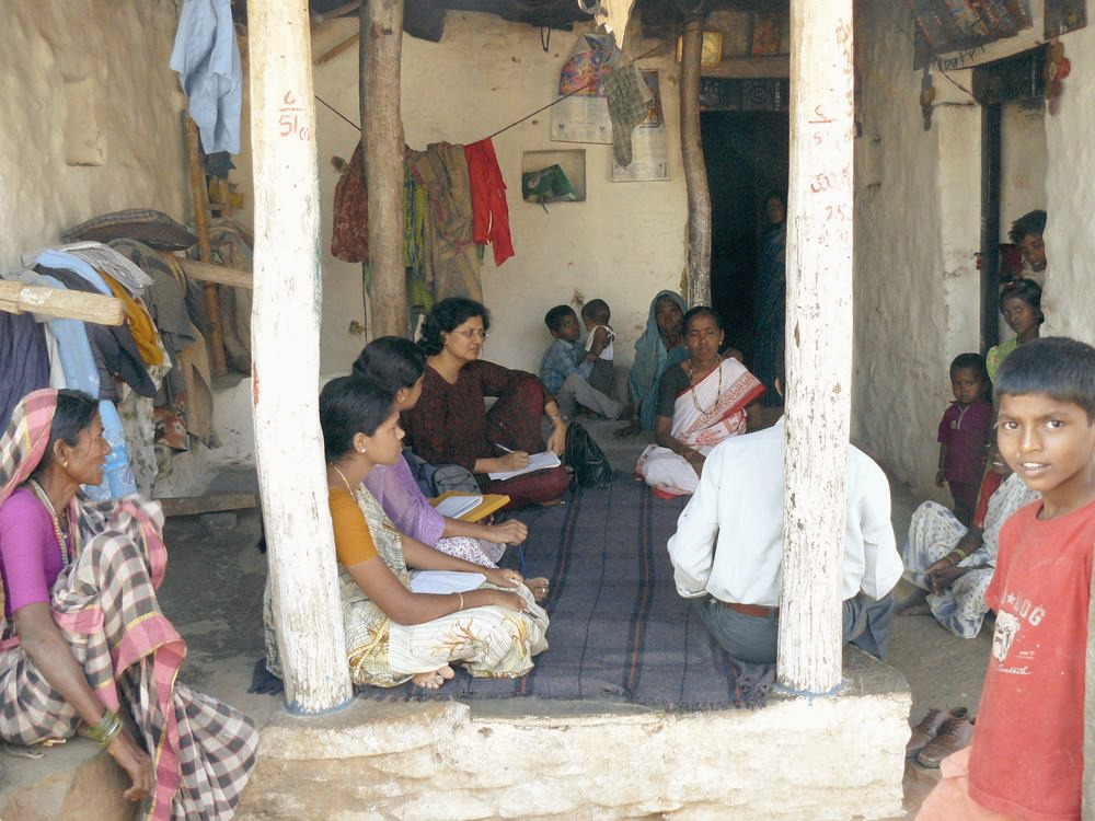 Kripa Ananthpur conducting an interview about the intervention with villagers